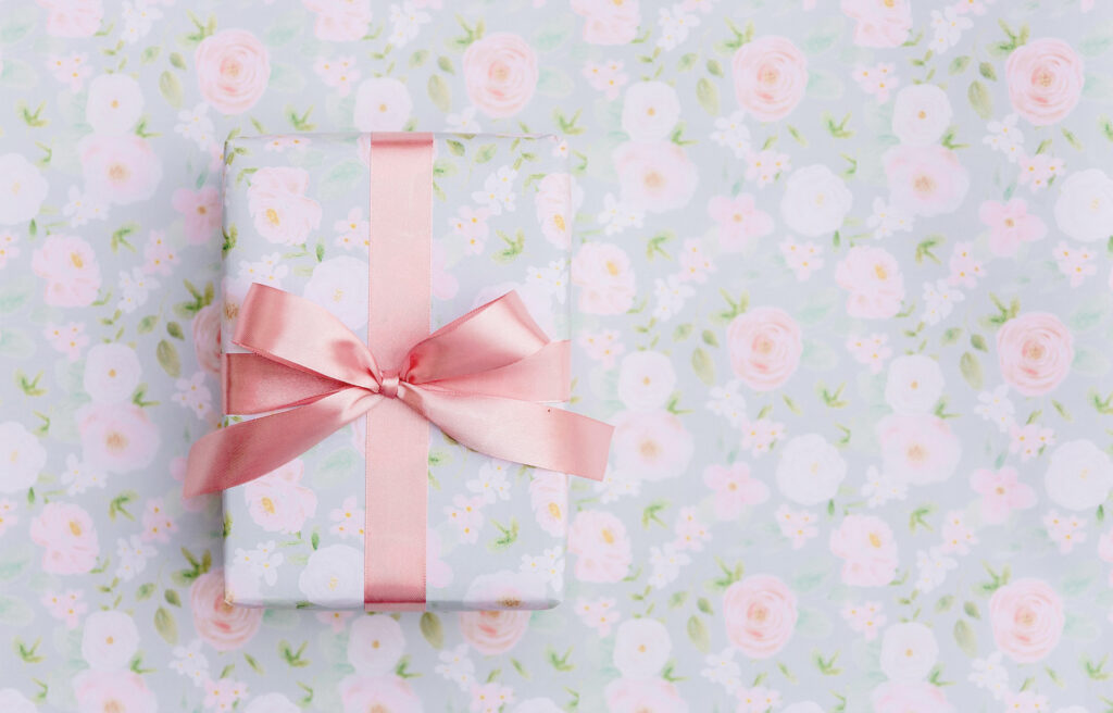 Gift wrapped in floral paper with pink silk bow - Header image for Lesson Learned Blog Post